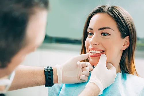 dentist inspecting a woman's smile