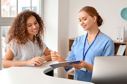 Staff showing a new patient something on a tablet